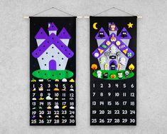 two black and purple wall hangings with houses on them