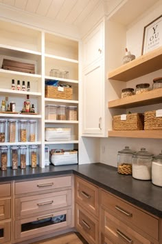 a kitchen with lots of shelves filled with food and containers on top of it's counters