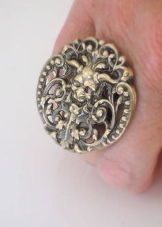 "Vintage Ring - Green Man Jewelry - Pan Ring - Devil Ring - Goth Ring - Celtic Jewelry - Fantasy Jewelry - Brass Jewelry - handmade jewelry This is such an awesome ring! A fabulous vintage brass stamping of Pan. Remarkable detail with a rich patina. This ring is adjustable. Chloe says, \"Wear it and feel fabulous!\" The ring measures 1 3/4\" round. Thanks for visiting Chloe's" Vintage Nickel-free Skull Ring For Gift, Vintage Nickel-free Skull Ring Gift, Handmade Adjustable Vintage Skull Ring, Handmade Vintage Skull Ring, Vintage Hand Cast Skull Ring As Gift, Vintage Hand-cast Skull Ring For Gift, Handmade Gothic Ring As A Collectible, Handmade Victorian Metal Rings, Handmade Gothic Gold Ring