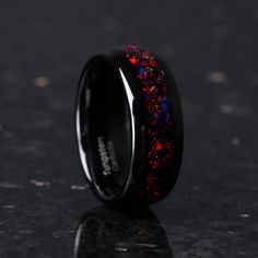 black ceramic ring with red and blue glitter inlay