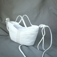 White rope mini tote shoulder bag handmade for women.  Middle Height: 14 cm  ( 5,51 ") Side Height:     16 cm ( 6,30 ") Top Width:   33 cm  ( 12,30 ") Bottom Width:  20 cm ( 7,87 ") Depth: 6 cm ( 2,36 ") Strap: 108 cm ( 42,52 ") The strap can be adjusted and tied to any length This white bag is made of fabric nylon rope. The rope is sewn with a zigzag seam on a typewriter. White rope mini bag has white cotton lining with zipper. Unique rope soft bag for women white color fashion style. Small rope bag with zipper white color handmade. Designer rope bag white handmade. White mini tote shoulder bag for summer vacations. Rope white purse bag with lining for woman unique. Unusual white rope mini bag for women. White Rope, Soft Bag, Rope Bag, White Cross, White Purses, Summer White, White Crosses, Color Fashion, Bag Handmade