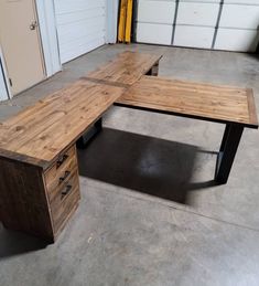 a wooden desk sitting in the middle of a garage