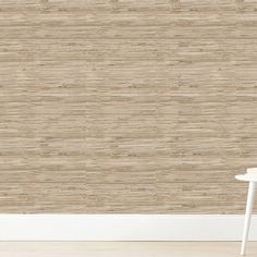 a white table sitting in front of a wall with a beige textured pattern on it