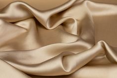 a close up view of a satin fabric with very soft folds on the edges and sides