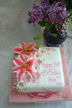 a birthday cake with pink flowers on it