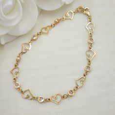 Modern solid 14k Hearts and round cz bezel bracelets. Perfect for everyday and every occasion. Elegant, modern and everlasting. 14k gold will not tarnish or rust. Materials: Solid 14k gold, clear zirconia diamonds. Lenght and weight:  8 inches - 4.9 grams (Weight are an approximate number) Stone size: 4mm. Hearts size: 7×10mm. 14k stamped.   Brand new. 💓 Briza Collections is a small family owned business that works hard on providing the best selection of Fine Solid Gold Jewelry for the best pri Yellow Gold Heart Bracelet In Cubic Zirconia, Yellow Gold Heart-shaped Cubic Zirconia Bracelets, Gold Cubic Zirconia Heart Bracelet For Valentine's Day, Heart-shaped Yellow Gold Bracelets With Cubic Zirconia, Heart-shaped Yellow Gold Cubic Zirconia Bracelets, Gold Heart Charm Bracelet With Cubic Zirconia, Yellow Gold Heart Bracelet With Cubic Zirconia, Yellow Gold Cubic Zirconia Heart Bracelet, Valentine's Day Yellow Gold Heart Bracelet With Cubic Zirconia