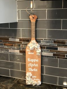 a wooden sign hanging on the side of a kitchen wall that says kapaa aloha