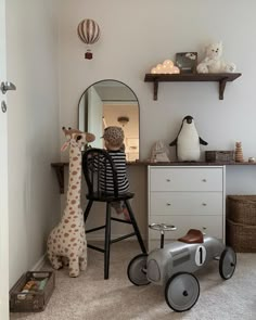 a child's room with toy cars, toys and stuffed animals on the floor