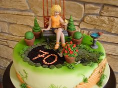 a birthday cake with a woman sitting on a bench