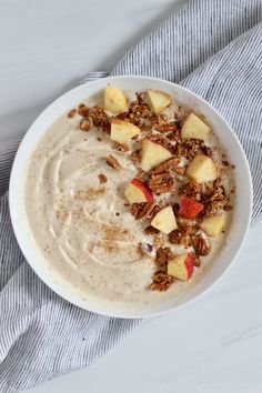 a bowl of oatmeal with apples and granola