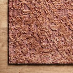 a pink rug on top of a wooden floor