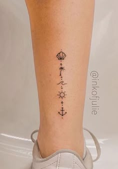 a woman's leg with a tattoo on it and an anchor in the middle