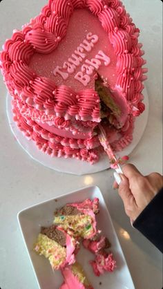 a heart shaped birthday cake with pink frosting