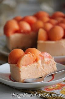 a piece of cake on a plate with a fork and some oranges in the background