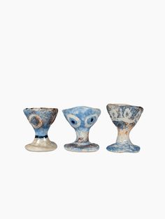 three blue and white vases sitting on top of each other in front of a white background