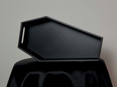 an empty black tray sitting on top of a table