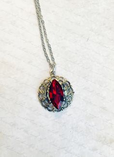 An antique treated silver filigree surrounds a deep ruby red diamond shaped rhinestone. The pendant measures a little under an inch in circumference.  It hangs from a silver toned adjustable chain that can be worn 18 to 20 inches  Light weight and delight, this is a beautiful timeless piece. The Red Queen, Necklace Elegant, Red Diamond, Red Queen, Pretty Jewelry, Diamond Shaped, Red Ruby, Silver Filigree, Rhinestone Necklace