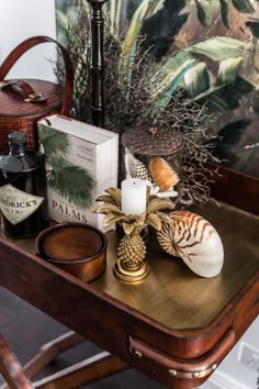 a wooden table topped with books and candles