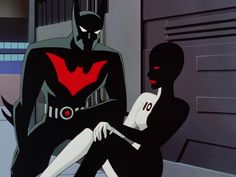 batman and catwoman sitting next to each other