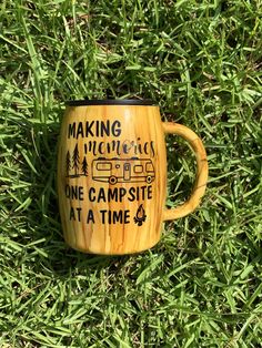 a coffee mug sitting in the grass with words making memories one campsite at a time