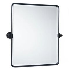 a mirror that is sitting on top of a wall mounted bracketed to the side of a white wall