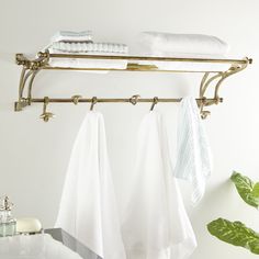 Add antiquated elegance to your entryway, bathroom, or bathroom with this antique-finished brass wall rack with 7 wall hooks. The shelf section is comprised of 7 brass hooks that securely cradle linens and towels, or hats and scarves if displayed in your entryway or bedroom. Beneath the brass rack are four metal hooks: two horizontal hooks on the outside and two standard vertical hooks between them. The ornate finial ends and golden brass finish complements vintage and antique style interiors pe Farmhouse Design Plans, Wall Mounted Shelving, Hook Shelf, Metal Wall Hooks, Rustic Wall Shelves, Copper Wall, Floating Wall, Wall Racks, Antique Farmhouse