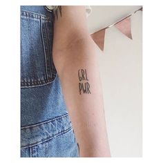 a woman with a tattoo on her arm that says gru par in cursive writing