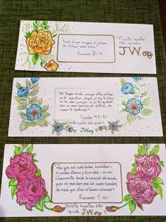 three envelopes with flowers on them sitting next to each other