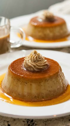 two white plates topped with desserts on top of a table