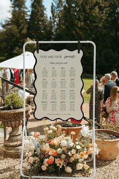 a sign that says you are our friends on it with flowers in the foreground