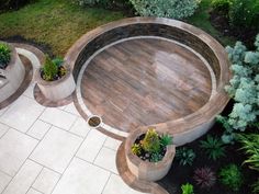 an aerial view of a circular patio with potted plants in the center and two planters on either side