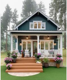 a small blue and white house with flowers on the front porch, steps leading up to it