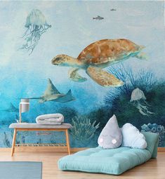 a living room with an ocean themed wallpaper and sea animals on the walls, including a turtle mural