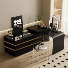 a black and gold desk in a room with mirrors on the wall next to it