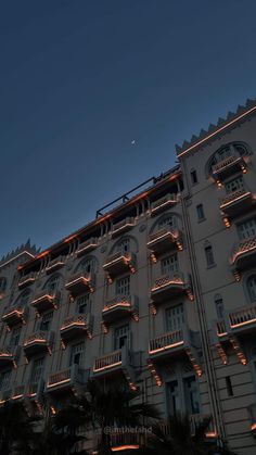 a large building with many balconies lit up at night