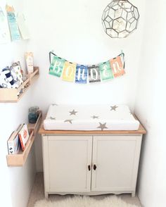 a baby's room with a crib and shelves on the wall next to it