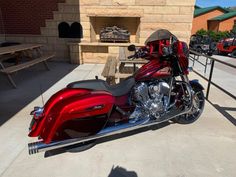 a red motorcycle parked in front of a building