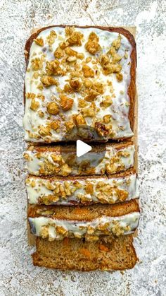 three slices of carrot bread with white frosting and walnuts on top, sitting next to each other