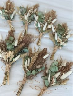 dried flowers are arranged on a white surface