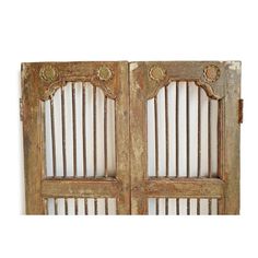 an old wooden double door with iron bars