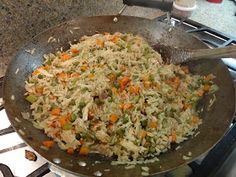 a frying pan filled with rice and vegetables