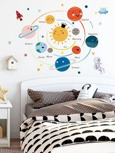 a child's bedroom with planets and stars on the wall