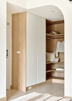 a bedroom with white closets and wooden flooring