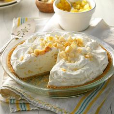 there is a pie with white frosting on the table