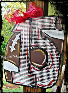 the number six is decorated with chocolate and red ribbon