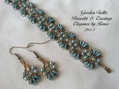 a pair of beaded and earring bracelets with dangling earrings on white fabric