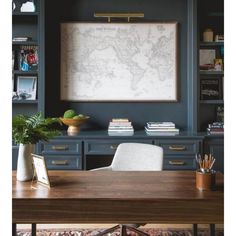 a desk with a map on the wall above it