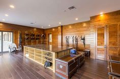 a large open room with wood paneling and lots of storage space on the walls