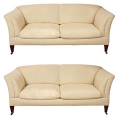 two cream colored couches side by side