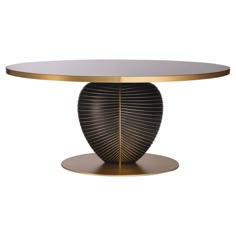 a round table with a gold base and an oval glass top on a white background